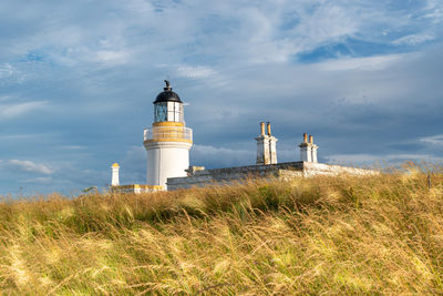 View of chanonry point lighthouse at sunset in summer in higlands of scotland.