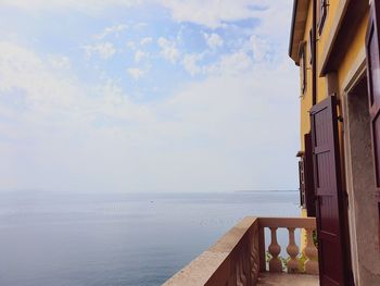 Scenic view of sea and buildings against sky