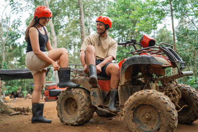 Rear view of family sitting on field