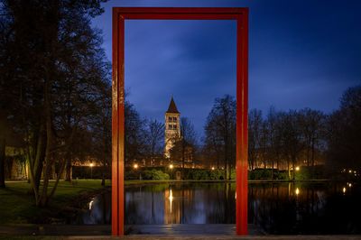 Reflection of building in lake at night