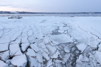 Blue hour morning late winter view of ice breaking on the banks of the st. lawrence river 