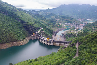 High angle view of river amidst mountains against sky