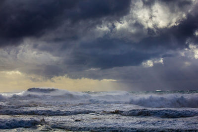 Scenic view of sea against storm clouds