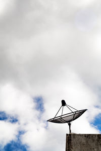 Low angle view of communications tower against sky