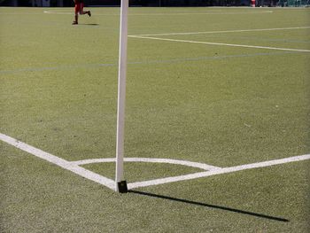 Low section of player running on soccer field