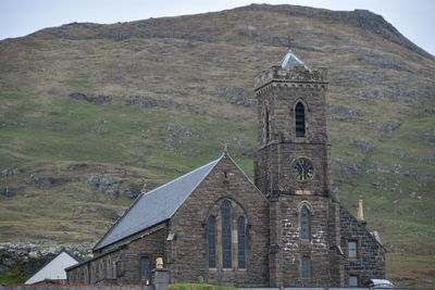 Low angle view of an old church against the hill