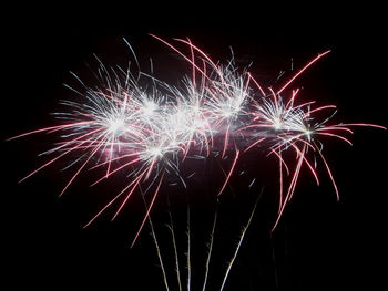 Low angle view of firework display at night