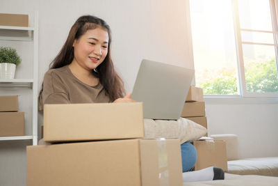 Portrait of smiling young woman using mobile phone