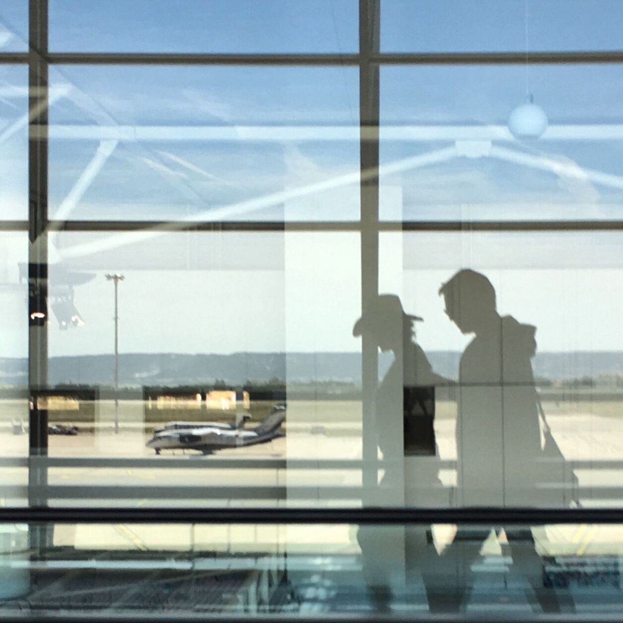 REFLECTION OF PEOPLE ON WINDOW