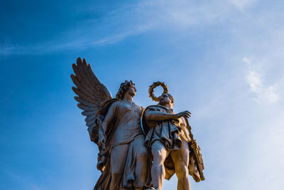 Low angle view of statues against sky