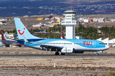 Airplane flying over airport runway