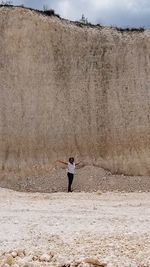 Woman standing in limestone quarry 