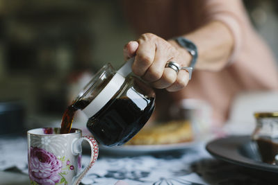 Hand pouring coffee