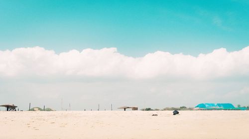 Scenic view of beach against blue sky