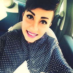 Portrait of young woman in car