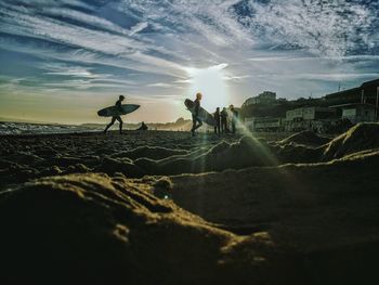 People on landscape against sky