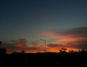 Silhouette landscape against sky at sunset