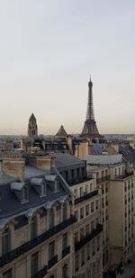 Buildings in city against clear sky