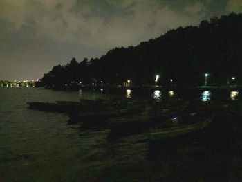 Scenic view of lake against sky at night
