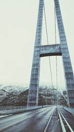 Low angle view of suspension bridge against sky