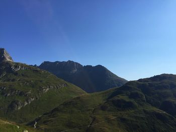 Scenic view of mountains against clear blue sky