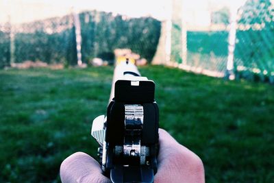 Cropped hand holding gun