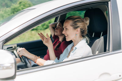 Portrait of smiling woman sitting in car
