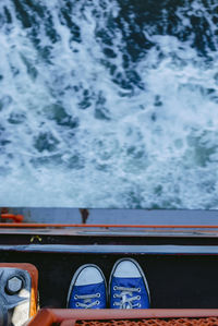 Directly above shot of shoes on boat in sea