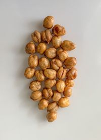 High angle view of coffee beans against white background