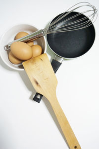 High angle view of bread and knife against white background