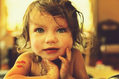 Close-up of cute baby girl at home