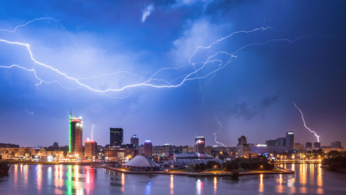 Lightning over river against sky