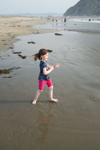 Full length of girl jumping on beach