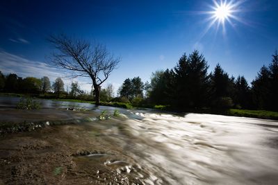 Scenic view of waterfall against sky