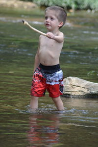 Boy standing in sea