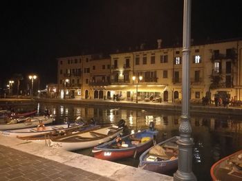 Boats moored in swimming pool at night