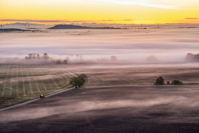 Aerial view at a sunrise with mist in the rural landscape