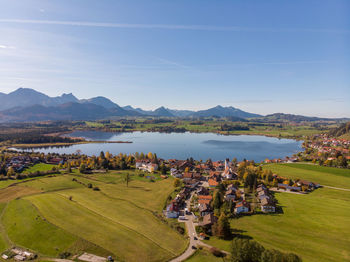 High angle view of hopfen village and lake hopfenser against sky