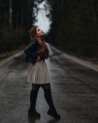 Young woman walking on road