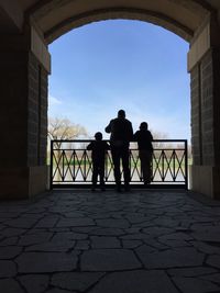 Men on sidewalk against sky