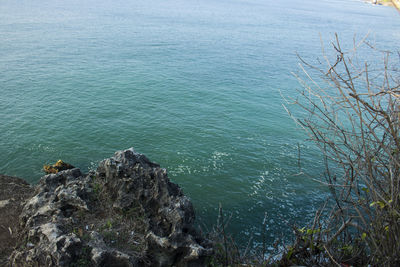 High angle view of rocks by sea