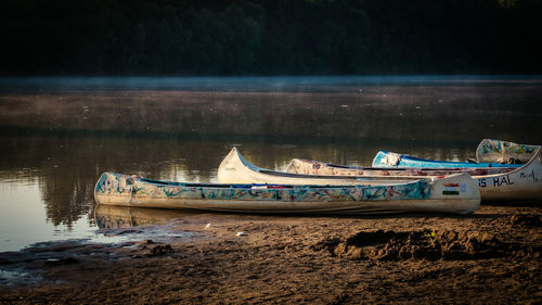 Boats moored in lake