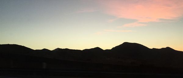 Scenic view of mountains against sky at sunset