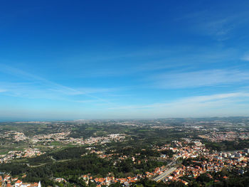 High angle shot of cityscape against blue sky