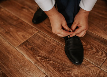 Low section of woman standing on hardwood floor