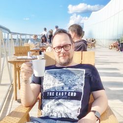 Portrait of a smiling young man with drink