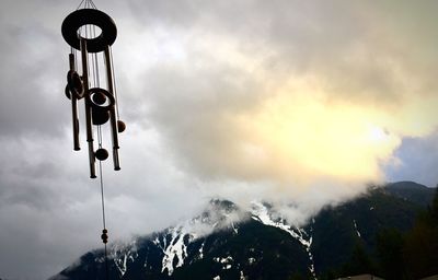 Low angle view of hanging lights against sky