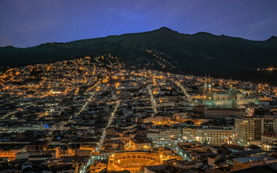 Aerial view of illuminated cityscape against sky at night