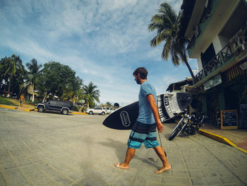 Rear view of man standing on road