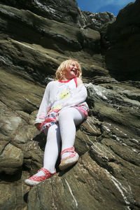 Woman sitting on rock